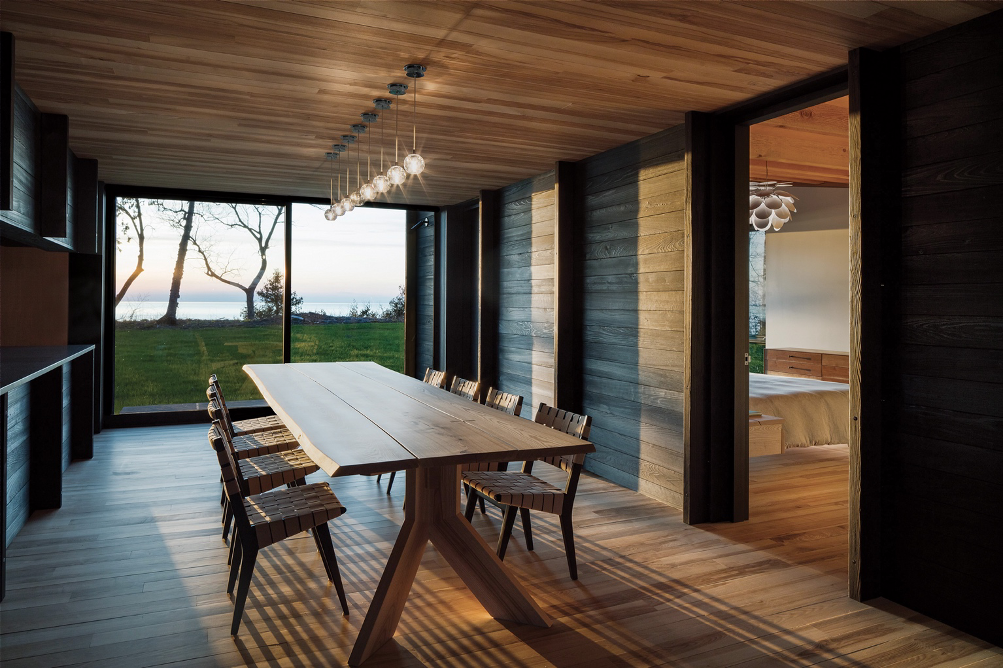 dining room with lake views and reclaimed raw-edge ash table from property's plagued ash trees