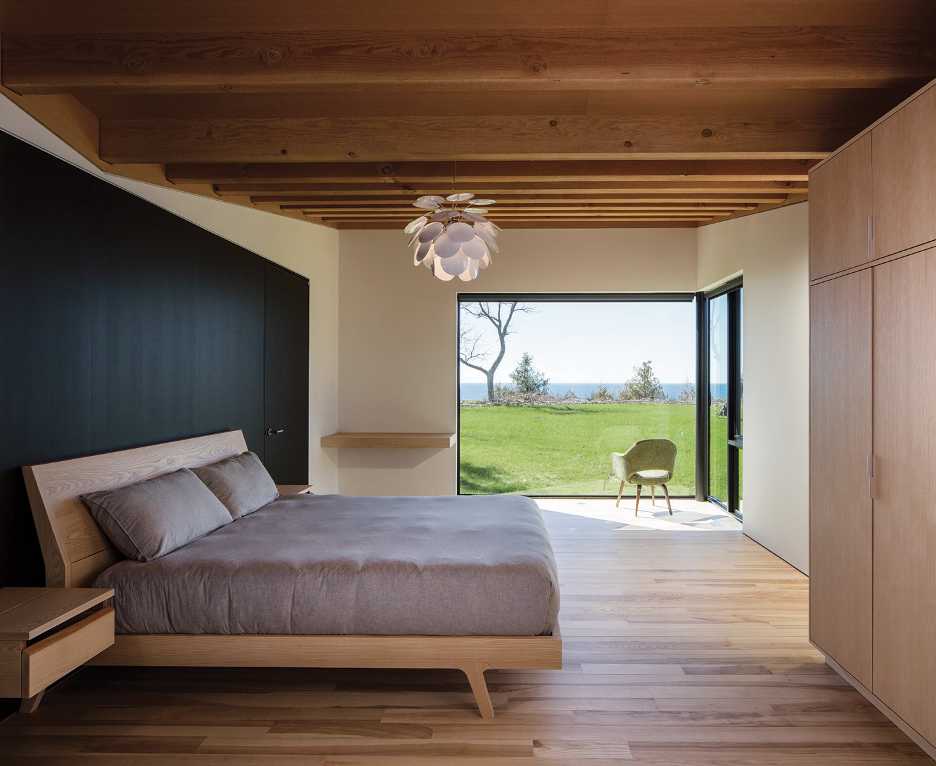 primary bedroom with lake view and custom ash platform bed