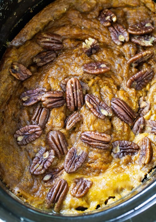 Pumpkin cake in a slow cooker topped with pecans