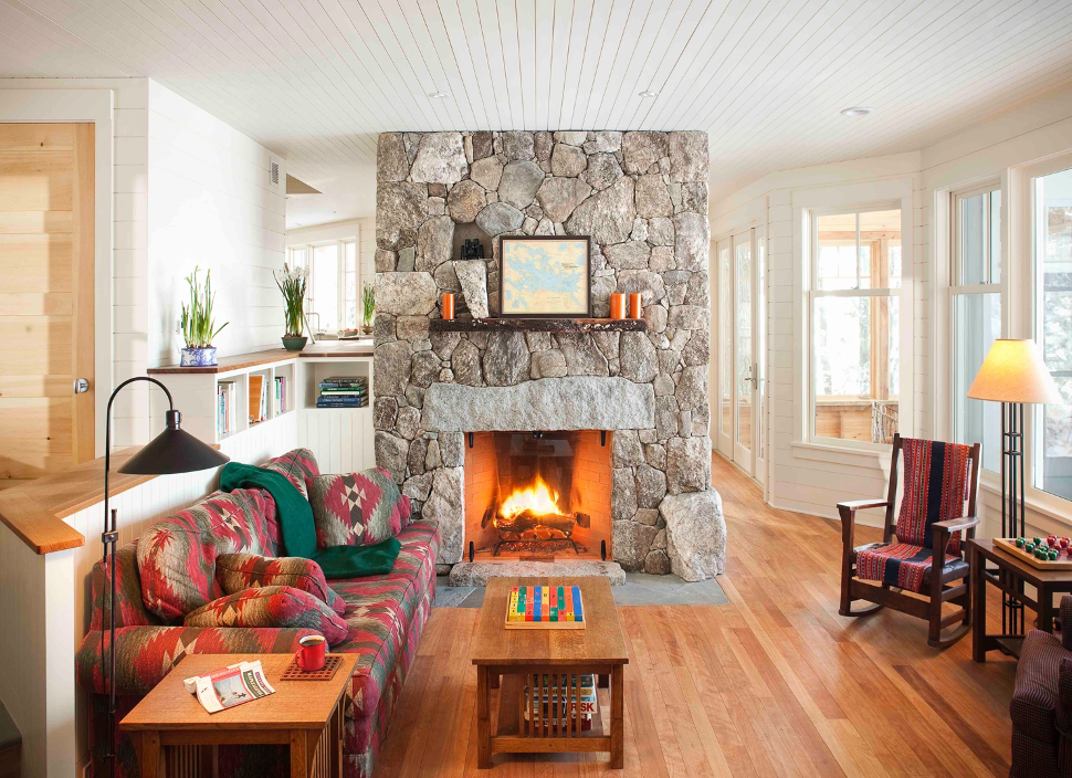 Lake home living room with stone fireplace