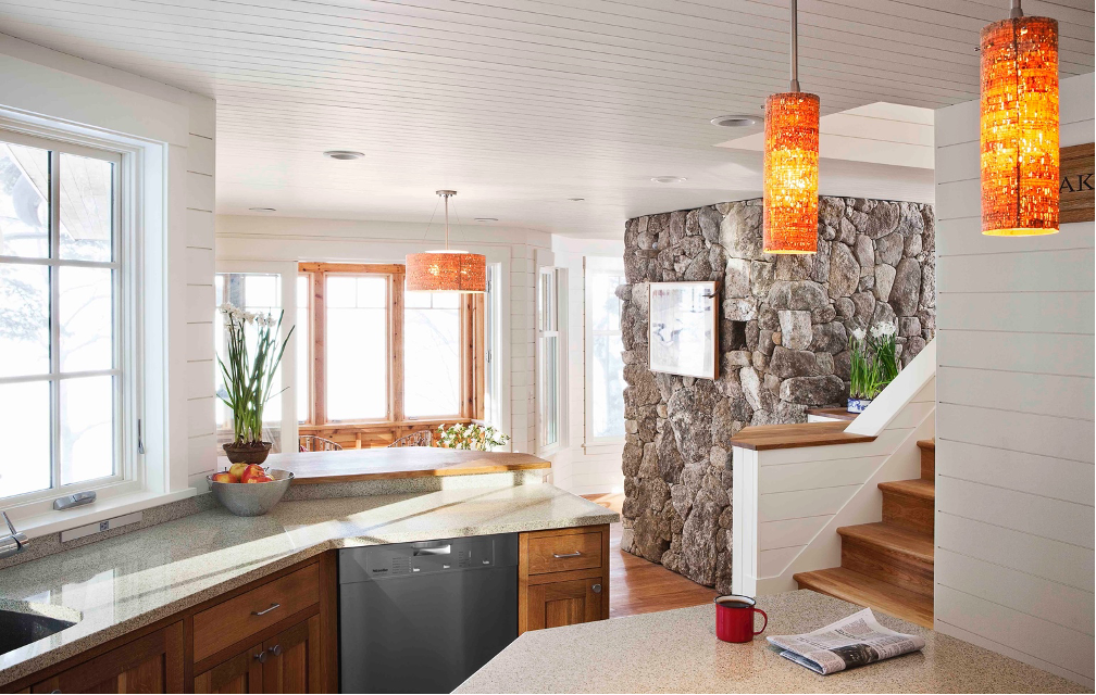 kitchen area with stone wall feature and stairway