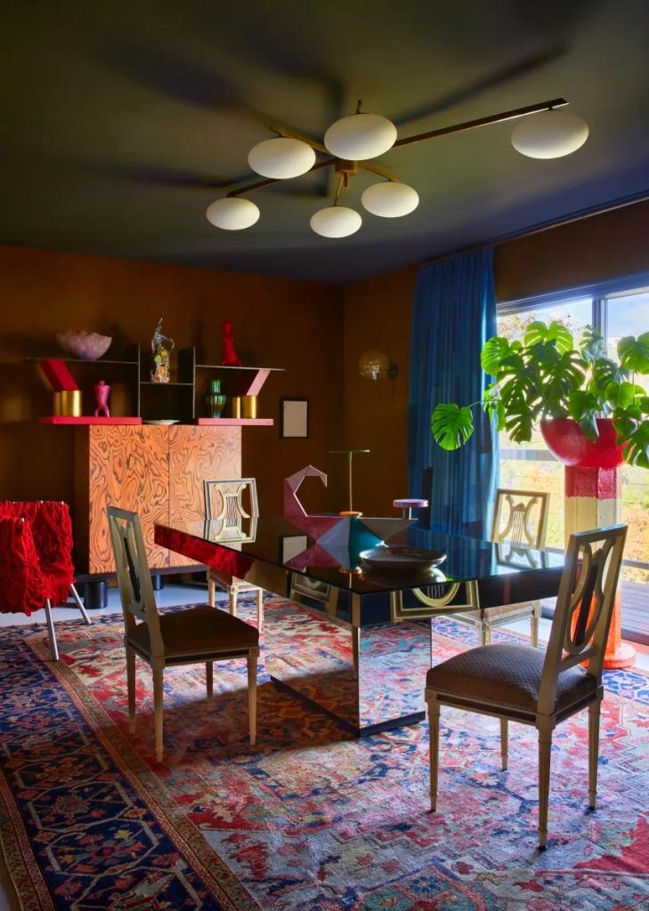 mirrored dining table in retro-inspired dining area with jewel-toned color palette