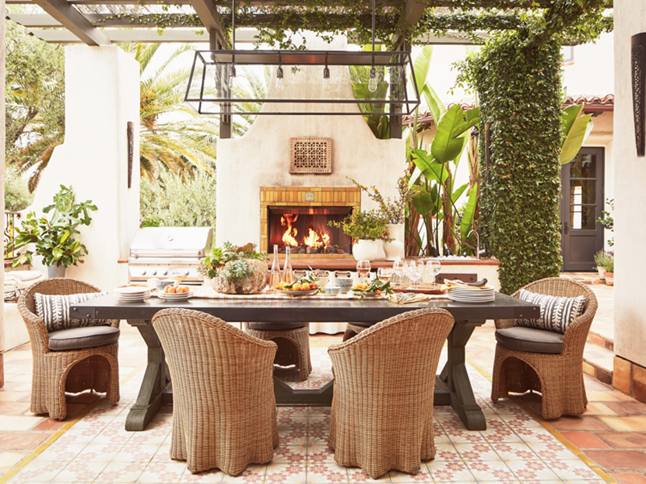 outdoor dining area with pergola and built-in fireplace
