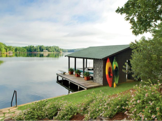 boat house with bright kayaks against boat house, vibrant lakeside landscape