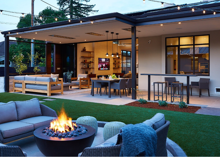 Covered and uncovered outdoor area with dining, comfy seating, TV, and outdoor fire pit seating area