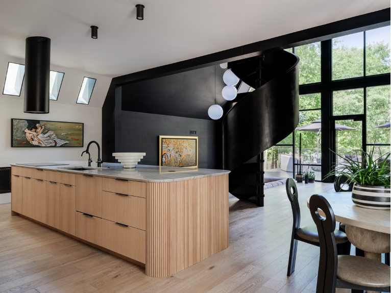 Kitchen and living room view with black spiral staircase and views outside