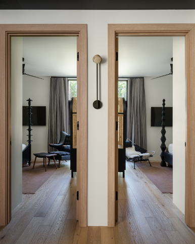 double guest suits with similar decor and black furnishings; guest bathroom with floating vanity and mirror