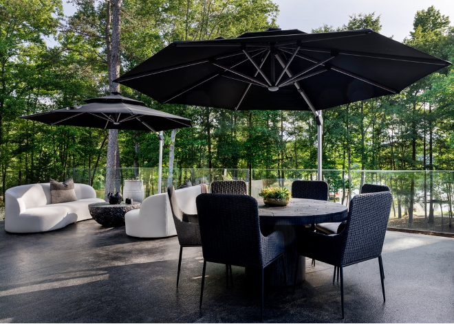 Back patio with seating and dining areas covered by black umbrellas