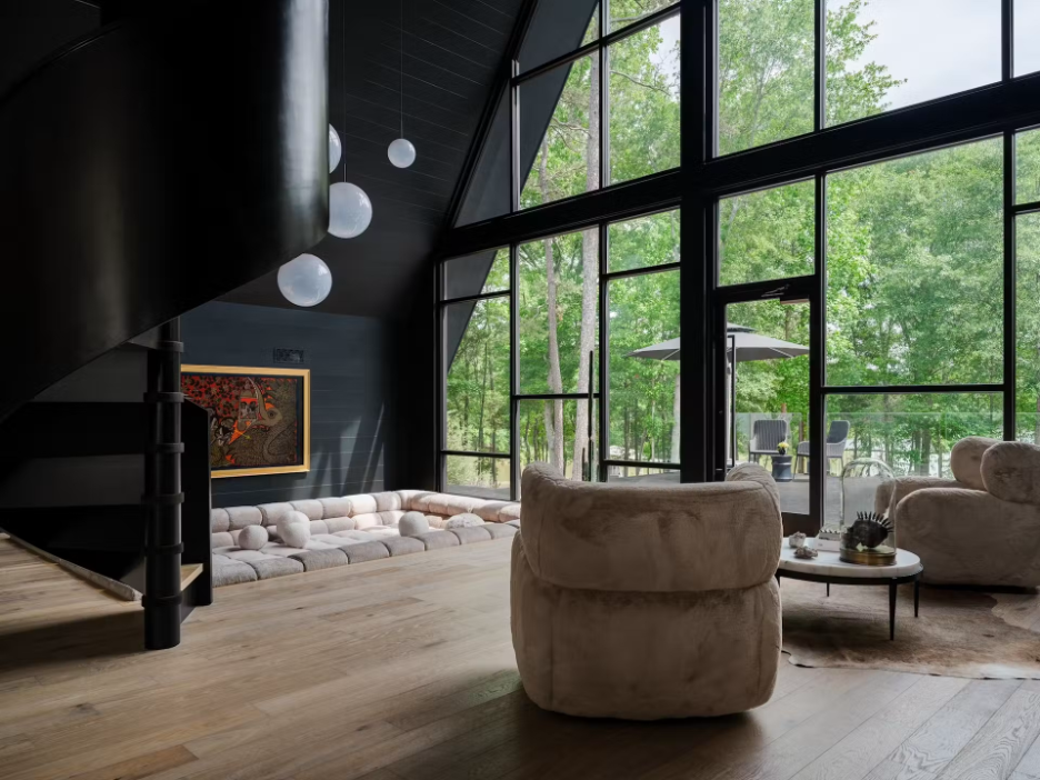 70s-style A-frame living area with conversation pit, spiral staircase, sitting area, and lush views of the lake landscape on Lake Hartwell, GA
