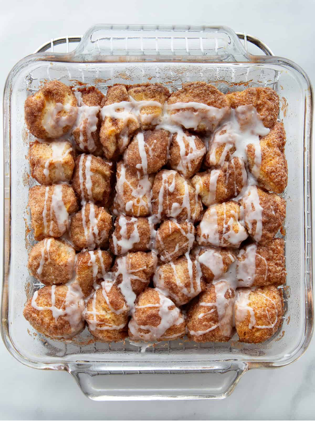 Easy Pull-Apart Coffee Cake in a glass baking dish and icing drizzled over the cake