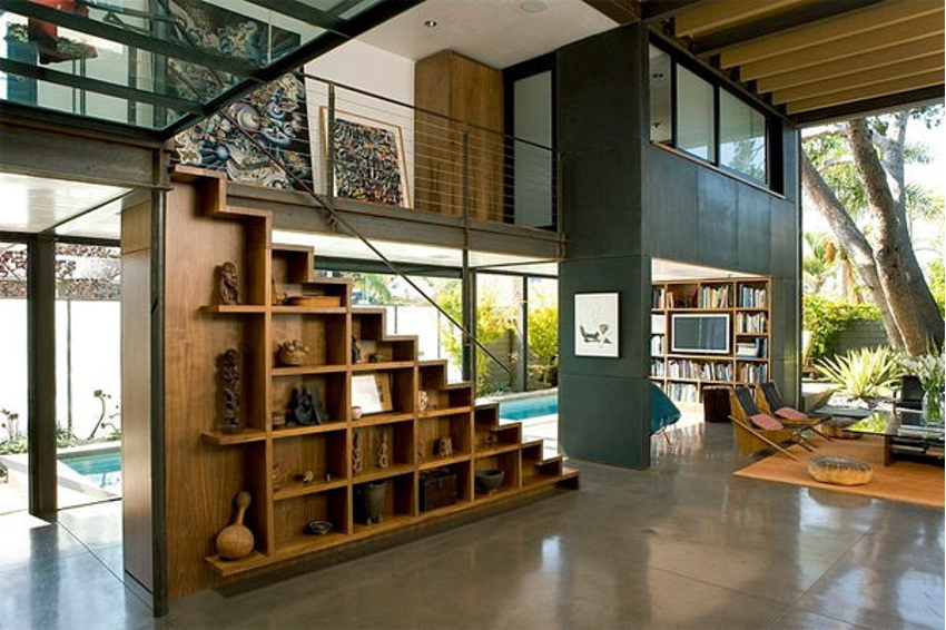Artistic open display shelving underneath the stairs with a collection of treasured objects from the homeowners' travel; contemporary West Coast design