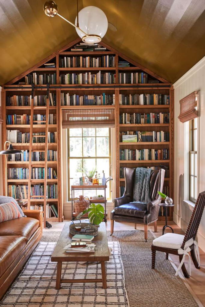 Built-in bookshelves scaling an entire arched wall in a lake home with a ladder