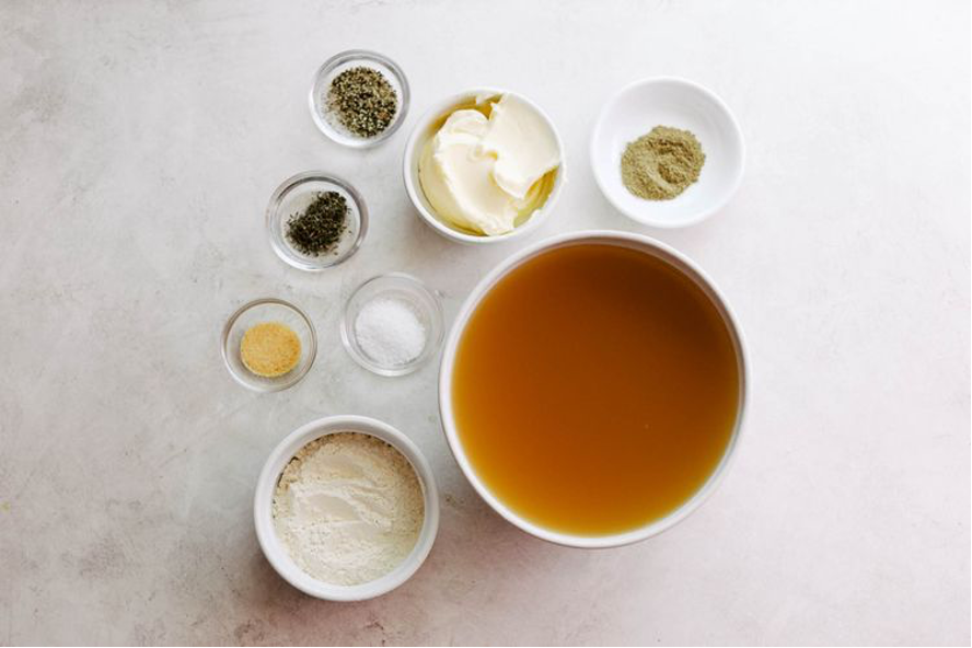 Ultimate Make-Ahead Gravy ingredients in separate ramekins on a table
