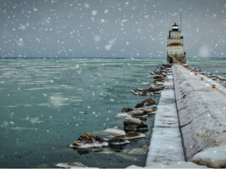 Snowfall from a pier stretching out into a northern great lake in the Wisconsin area