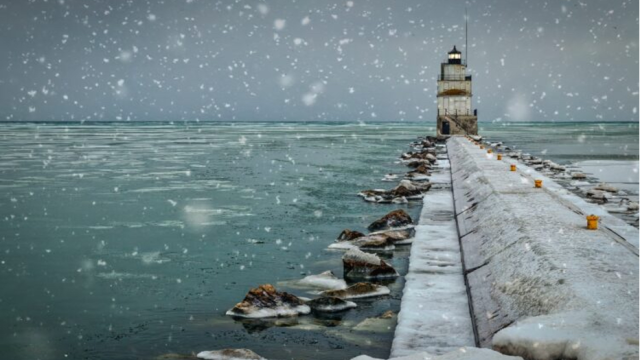 Snowfall from a pier stretching out into a northern great lake in the Wisconsin area