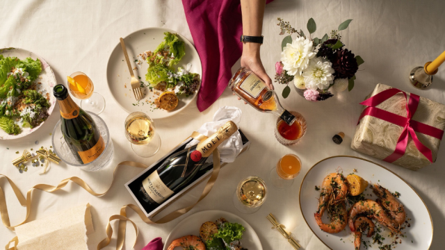 Festive NYE table with various foods and Champagne