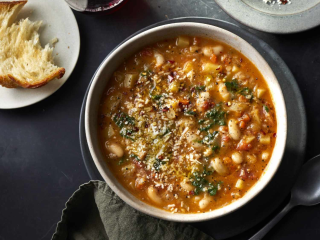 Ribolitta recipe from Food & Wine served in a rustic bowl with bread