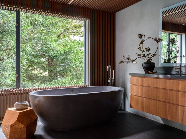 Japandi-style bathroom with black soaking tub, natural wood embellishments, connection to the outdoor scenery