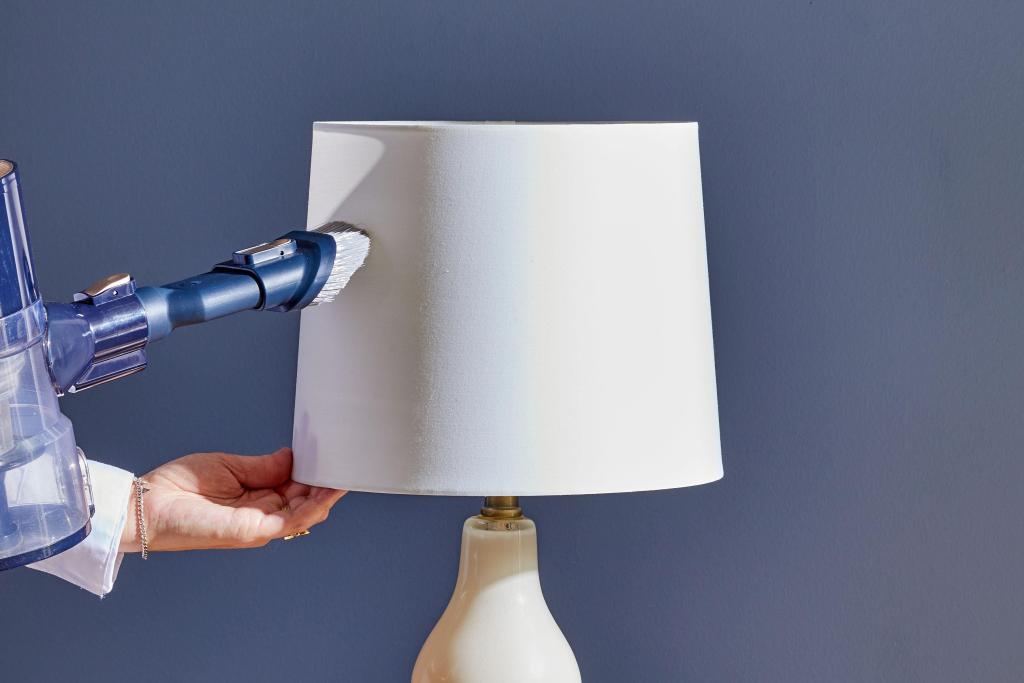 cleaning dust from a lampshade
