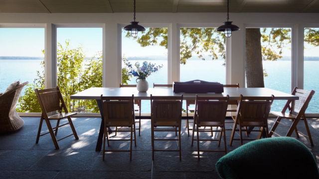 summer porch at a Maine lake home with dining table and chairs overlooking the water and landscape