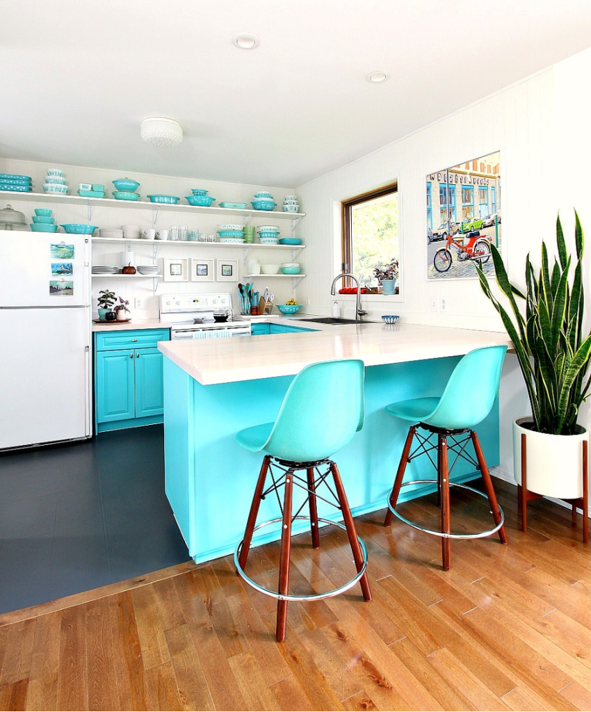 Stacked Vibrant Turquoise Tableware as Functional Decor displayed on open shelving in a tiny lake home kitchen