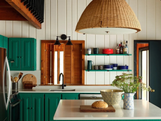 lake home kitchen with green cabinetry and an accent wall with floating shelves