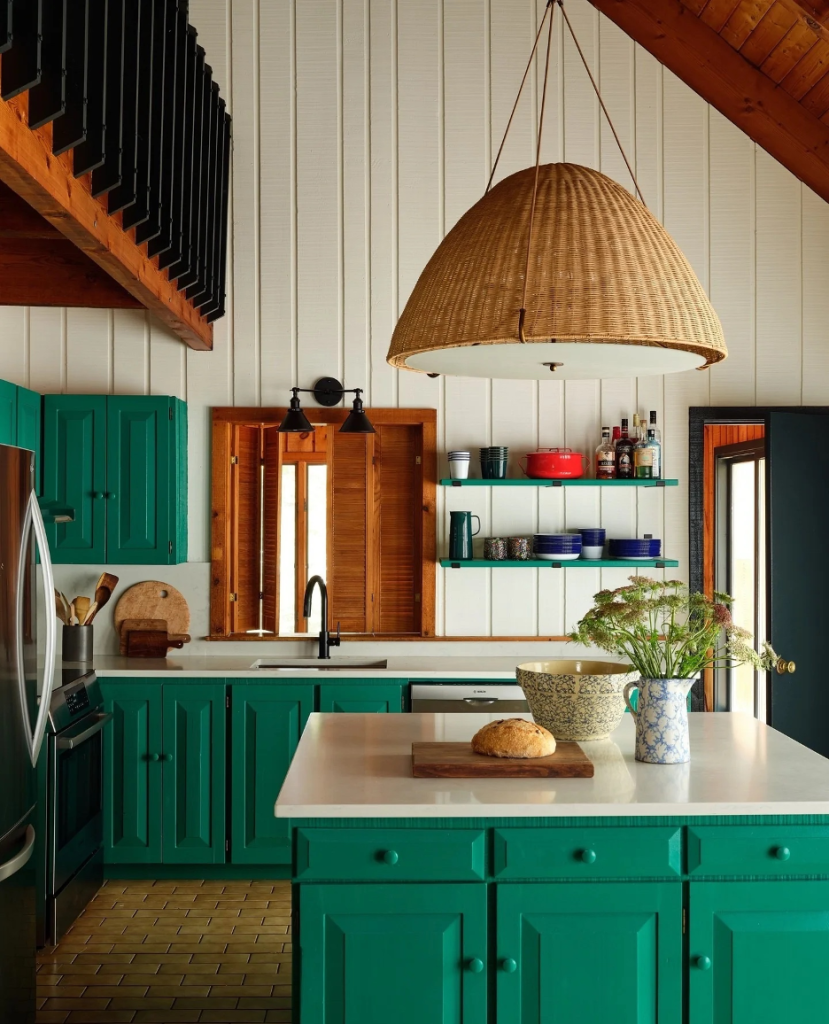 lake home kitchen with green cabinetry and an accent wall with floating shelves
