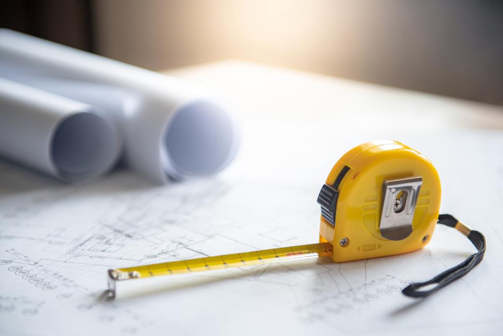 tape measure and blueprints illustrating How Do I Calculate Square Footage?